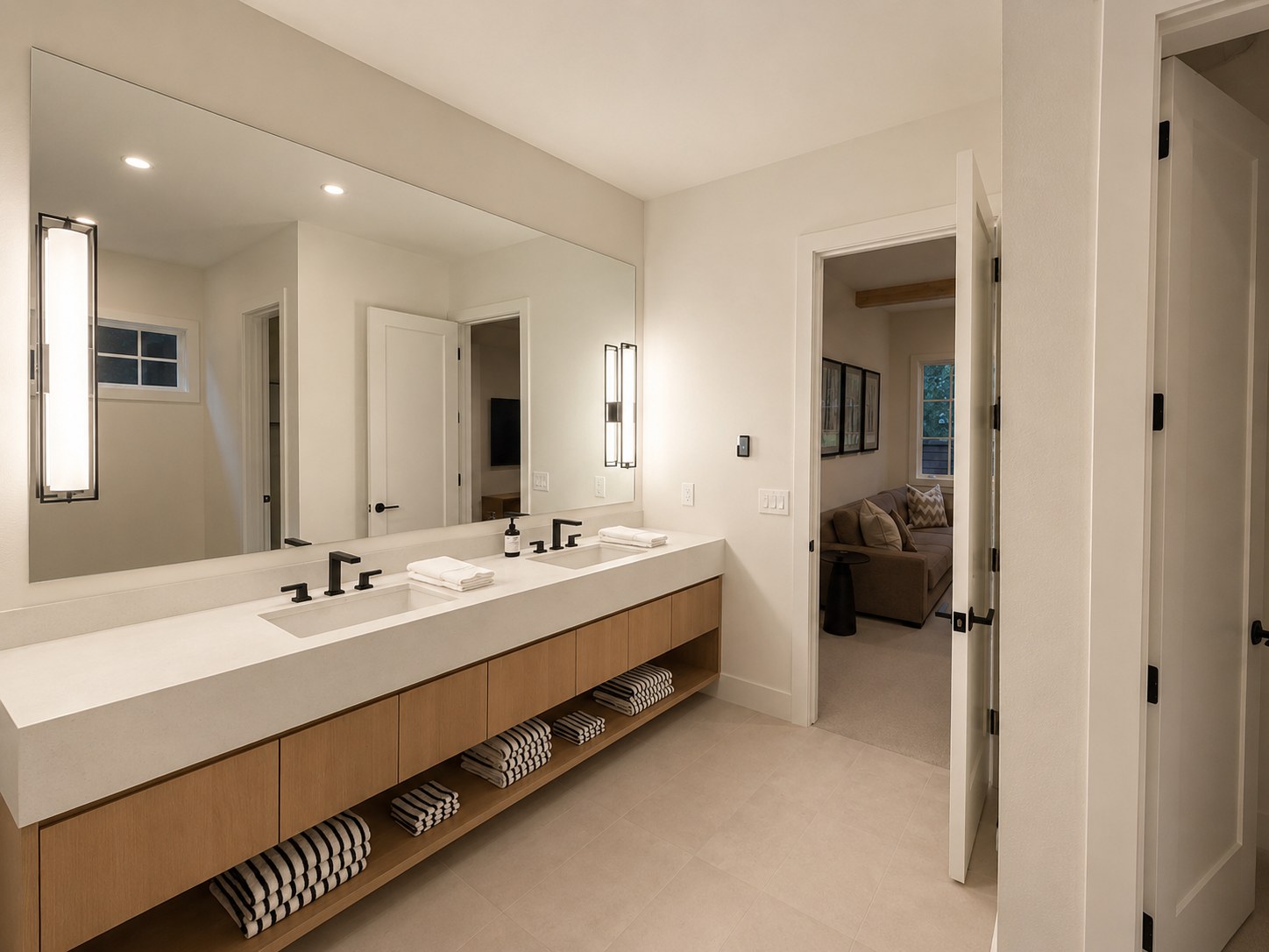 Floating white oak double vanity with frameless mirror, matte black faucets, and open lower shelving — master bath remodel, Broken Top Bend Oregon