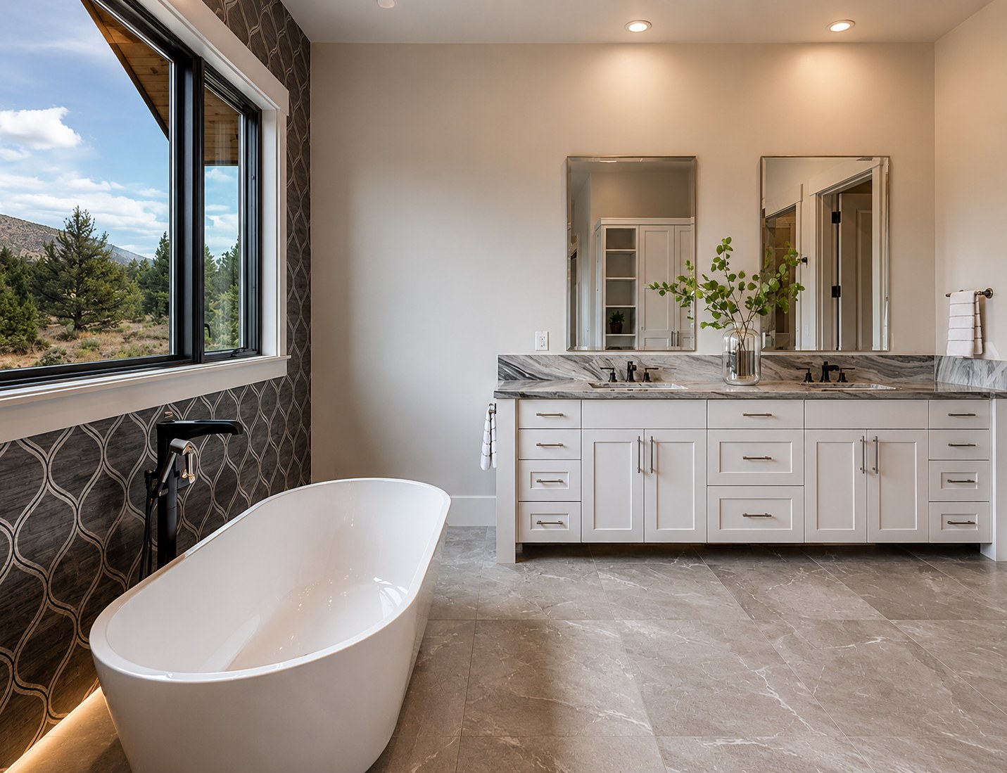 Brasada Ranch custom home master suite — freestanding soaking tub, decorative tile feature wall, white double vanity, marble countertop, mountain views — LT Northwest Builders