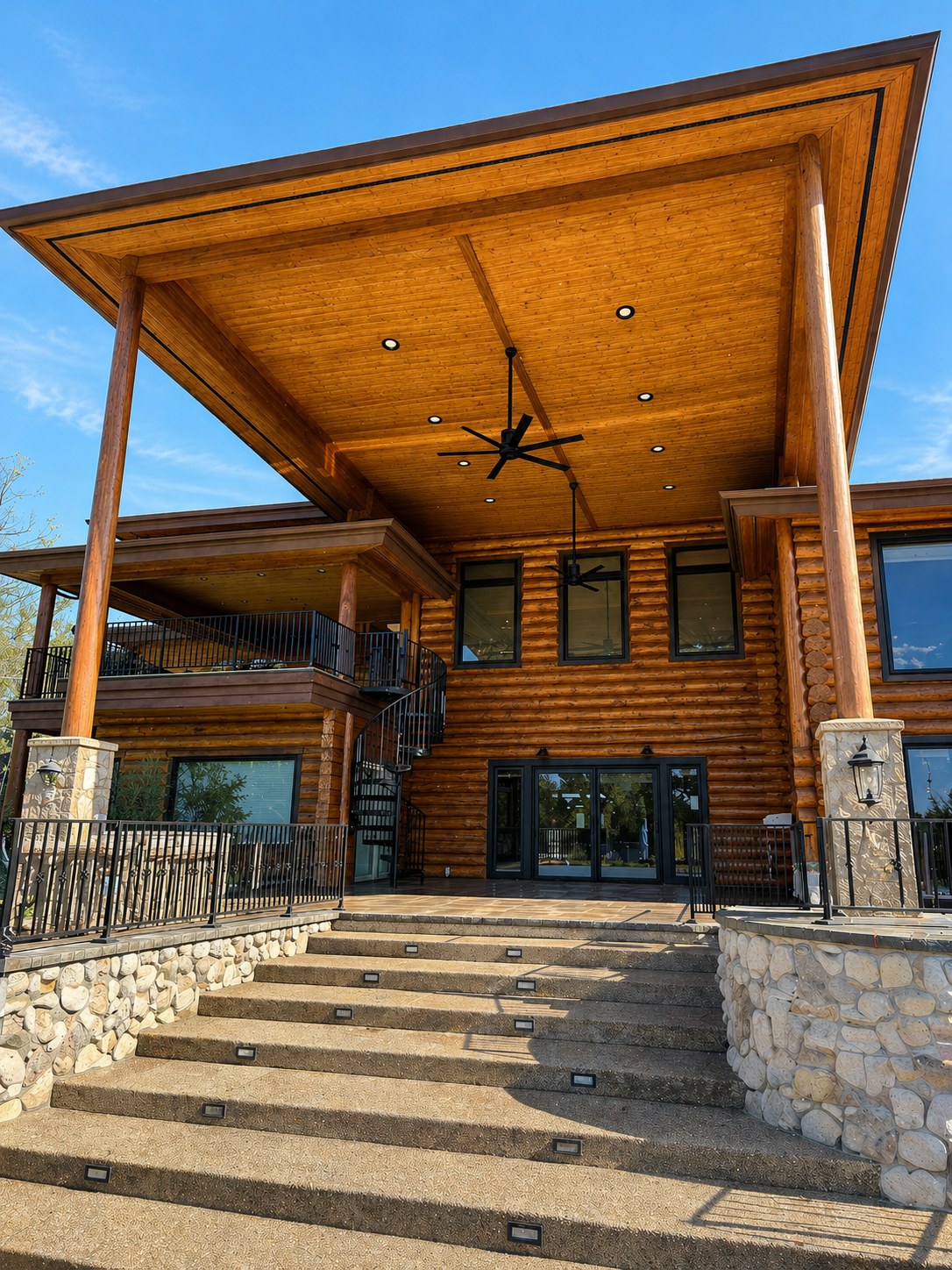 Central Oregon ranch — 25-foot log and stone roof structure, cedar coffered ceiling with recessed lighting, spiral staircase — LT Northwest Builders
