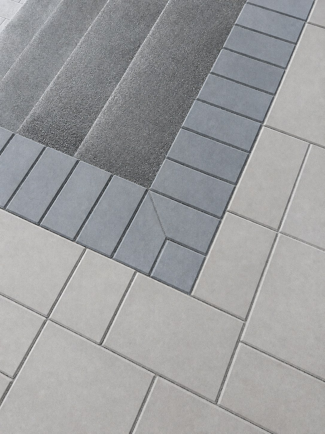 Central Oregon ranch — custom patterned paver deck detail, multi-tone paver pattern with concrete step edging — LT Northwest Builders