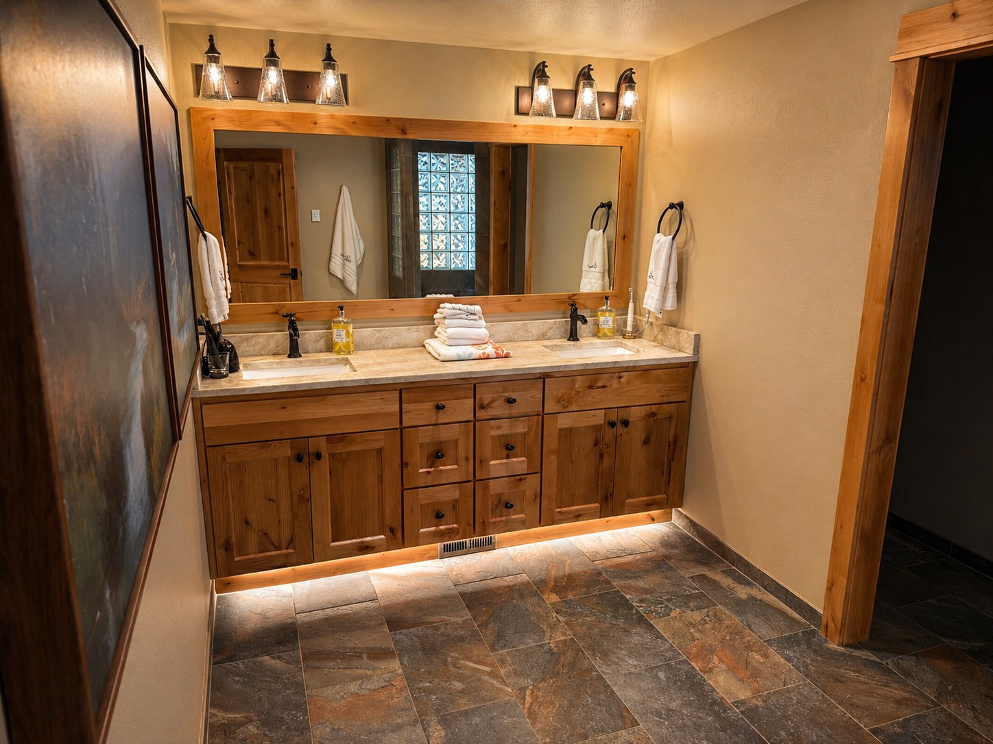 Sunriver remodel master bath — double-sink alder vanity, slate tile, LED under-cabinet lighting — LT Northwest Builders